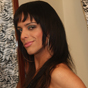 Vivy Aguilera is a beautiful brunette transsexual from Porto Alegre. She has a long, slender body and an even longer cock. While wearing stiletto boots and fishnet stockings, she spreads her legs on the bed and shows off her tight she-pussy.
